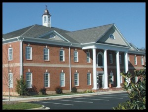 Exterior of BridgeMill office. Red bricks with white pillars in front.
